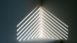 © siriwan - Light casts sharp diagonal stripes across a dark corner