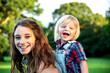 © Rawpixel.com - Smiling woman with braces and a laughing child in a sunny park.