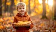 © hellow - Happy child holding pumpkin pie outdoors.