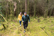 © Cavan - Couple hiking through a mossy forest exploring nature