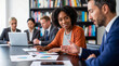 © Athena Studio - Photograph of diverse business professionals collaborating in a modern office meeting room.
