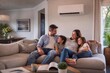 © Sammar - Happy Family Enjoying Indoor Comfort with Modern Air Conditioning System at Home