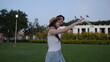 © blueringmedia - Young Asian Couple Sightseeing in a Park During Evening Sunset