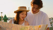 © blueringmedia - Young Asian Couple Reading a Map by the Riverside at Sunset