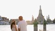 © blueringmedia - Young Couple Looking at Wat Arun Temple Across the River