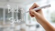 © Vero - Child hand writing Back to School message with marker