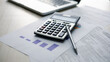 © DK_STUDIO - audit auditing auditor.Calculator, financial reports, tax documents, and laptop on an office desk illustrate accounting, auditing, budgeting, financial analysis for business planning and compliance.