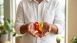 © mother - Red and yellow awareness ribbon in hands, hepatitis awareness concept, person holding medical support symbol