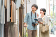 © buritora - Young couples enjoying walking tours and sightseeing in cities during domestic travel.