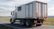 © Farid - Commercial white box truck driving on country highway road under blue sky