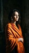 © Bersalin - Pensive young woman wrapped in a warm orange shawl