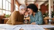 © PixelVision Studio - Senior mentor and mentee sharing a laugh while collaborating on blueprints in a co-working space