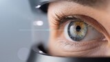Close up view of a person undergoing an eye examination in a clinic with a device focused on the eye during the testing process