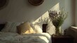 © Alfath - Morning sunlight streams across a cozy bedroom setting illuminating pillows and a vase of dried botanicals.