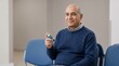 © Elysian Essence - Senior Middle Eastern man with inhaler, Asthma clinic appointment, Respiratory healthcare waiting room, Calm medical portrait