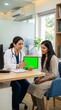 © Adweeyd - Healthcare technology mockup showing a doctor holding a tablet with chroma key screen during a patient consultation in a modern clinic. Suitable for medical software, telehealth applications