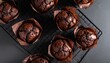© Febriyan - Freshly baked chocolate muffins cooling on a wire rack top view