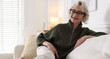 © New Africa - Portrait of senior woman on sofa at home. Space for text