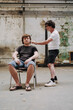 © Luciano Spinelli/Stocksy - Styling the hair of a teenage boy on flip-flops