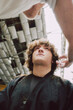 © Luciano Spinelli/Stocksy - Barber Giving Haircut to teen z generation