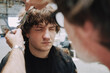 © Luciano Spinelli/Stocksy - Hair Styling Process in a Creative Studio Setting