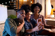 © Jovo Jovanovic/Stocksy - Daughter taking selfie with parents during outdoor evening