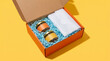 © Studio Fiuza - Top view of an open corrugated cardboard gift box filled with artisanal fruit jam jars and blue shredded packing paper. Perfect for unboxing concepts, e-commerce delivery, packaging mockups.