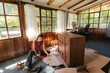 © Luis Herrera/Stocksy - Young Woman Assembling Furniture in Bright Home
