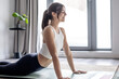 © luciano - Young Woman Practicing Yoga At Home On Mat Doing Upward Dog Pose For Fitness