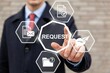 © Tech_Lab - Businessman pressing a virtual button with the word request on a digital interface screen