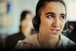 © DragonImages - Close up of young adult woman wearing headset, assisting customers in call center office and supporting service operations. Ideal for customer support, CRM, contact us marketing