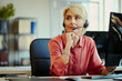 © DragonImages - Middle aged Caucasian woman wearing headset, assisting customers and monitoring computer in call center office. Ideal for customer support, CRM, contact service marketing