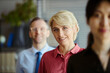 © DragonImages - Portrait of middle aged Caucasian businesswoman leading call center team in office, representing customer support and teamwork. For service branding, HR recruitment, corporate communication