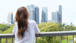 © blueringmedia - Asian Woman Looking at Bangkok City Skyline from Benchakitti Park Bridge