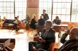 © Rawpixel.com - Diverse business professionals networking in a sunlit modern office lounge