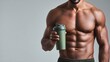 © Thailand Smile - Muscular fitness athlete holding a red protein shaker bottle. Fit man and bodybuilder with sports nutrition supplement container.