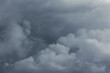 © senerdagasan - Dramatic gray clouds in the sky. Dark storm weather background.