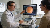 Doctor showing a retinal scan on a monitor to a patient during an eye clinic consultation visit