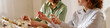 © AnnaStills - Website banner of women testing perfume samples and spraying fragrance on wrists during product selection, showing beauty retail decision making