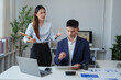 © Tj - Asian business woman employer expressing anger and frustration towards male employee during a conflict at work, creating stress and a toxic workplace environment