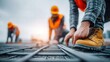 © Visglow - A construction worker is focused on the rebar while working on a building project.