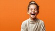 © MarkelovaVision - Joyful girl with a big smile against an orange background