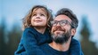 © RndVisuals - Father and child looking up together with smiles, enjoying a moment outdoors