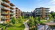 © horizon - Contemporary residential apartment buildings with glass balconies and wood accents feature a lush green courtyard beneath a clear morning blue sky.