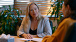 © Maksym - Volunteer burnout counseling session with a nonprofit program manager gently guiding an emotionally drained field volunteer through a debrief worksheet at a conference table, box of tissues nearby,
