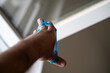 © Mihail - Close-up of hand using resistance bands for finger exercise and rehabilitation