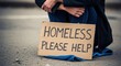 © MST._RUNA - Homeless person holding a cardboard sign asking for help