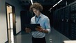 © Mehwish - Experienced IT specialist holding a sleek generic blank tablet for digital workflow or software development, photorealistic high-tech office interior with modern equipment and clean design.