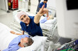 © Guille Faingold/Stocksy - Doctor Assists Patient in Hospital Room