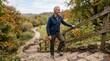 © Carina - Active senior man smiling while climbing up stone stairs in an autumn park